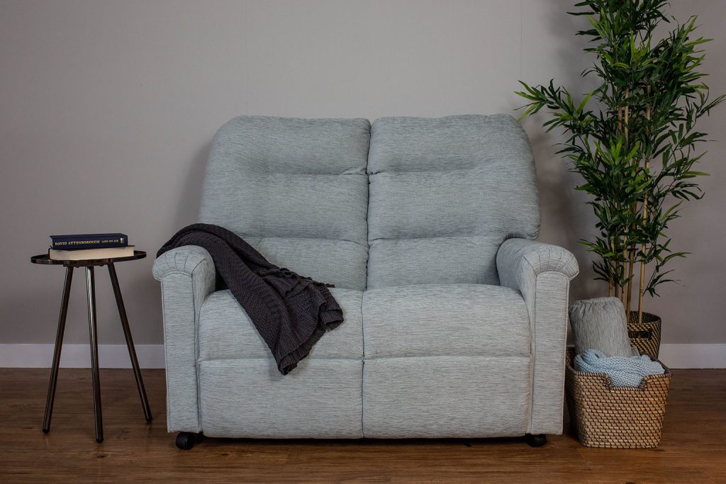 A blue two seater sofa.