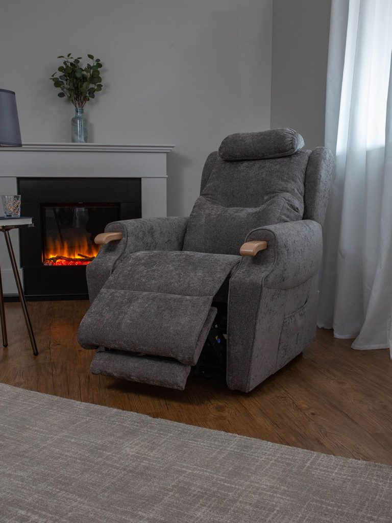A grey riser recliner chair in a reclined position. 